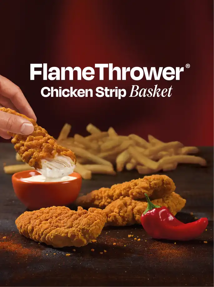 A hand dipping a Flamethrower chicken strip into dip