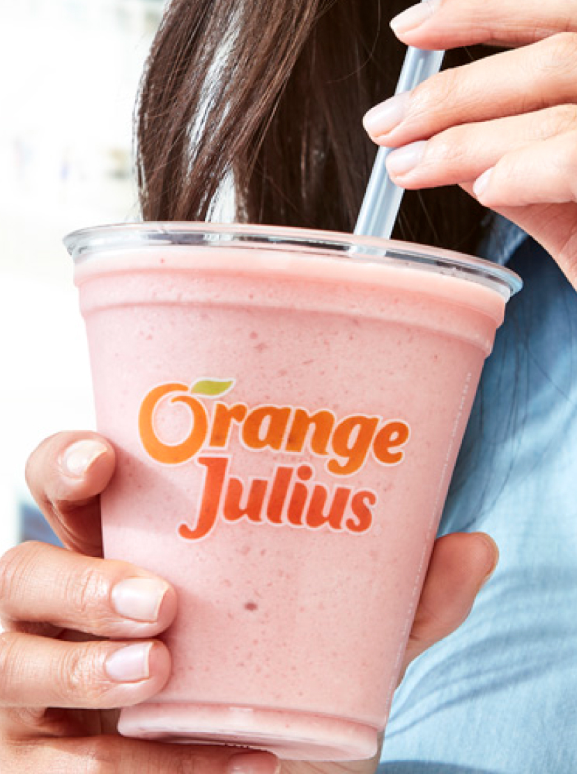 Woman sipping from Orange Julius Smoothie