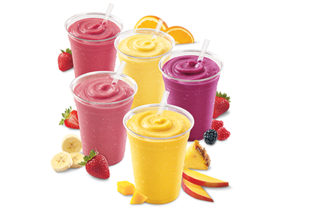 Five different smoothie drinks with an array of fruit slices